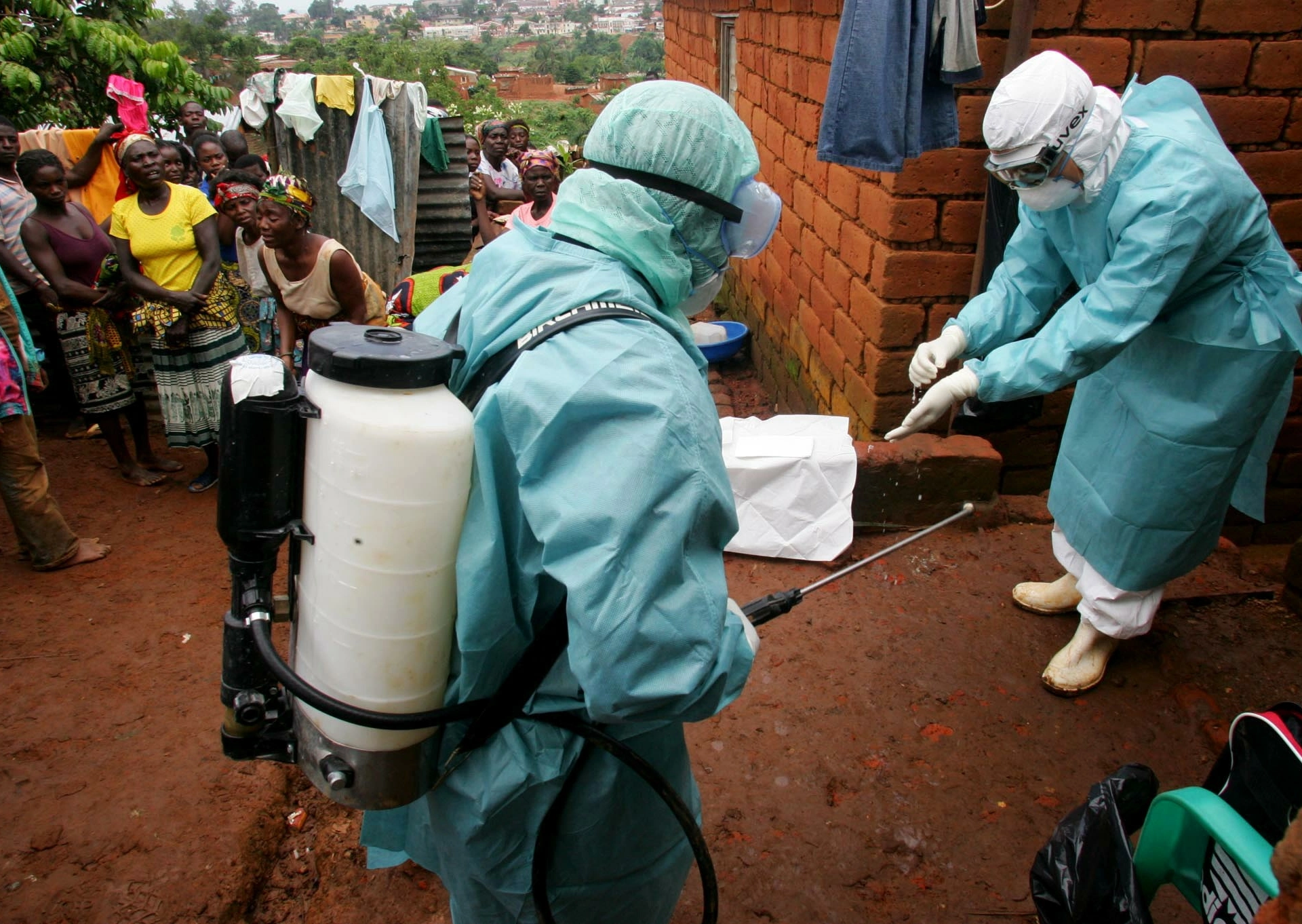 WHO officials examine the home of a suspected Marburg virus victim in the northern Angola [File: Reuters]